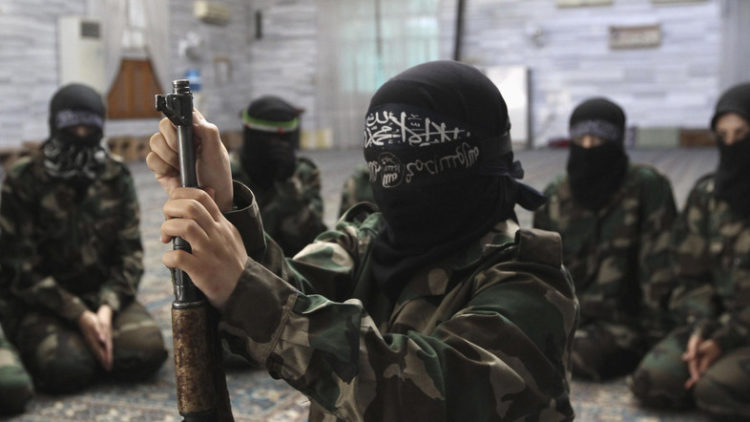 A female member of the Ahbab Al-Mustafa Battalion assembles a rifle during military training in a mosque in the Seif El Dawla neighbourhood in Aleppo