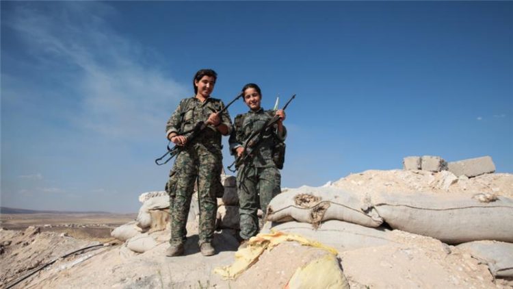 YPG women fighters in a check point at the outskirts of the destroyed Syrian town of Kobane [Getty]